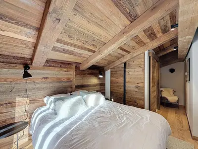 a bedroom with wooden walls and a white bed at Appartement élégant 4 chambres - Combloux, proche Mont-Blanc - FR-1-560-171 in Combloux