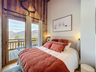 a bedroom with a large bed and a large window at Appartement élégant 4 chambres - Combloux, proche Mont-Blanc - FR-1-560-171 in Combloux