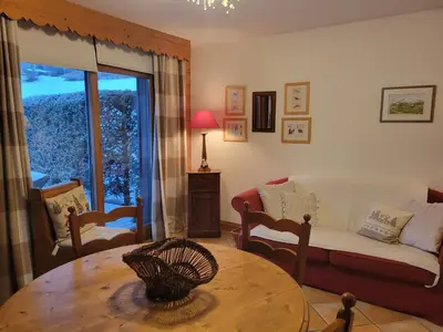 a living room with a couch and a table at Les Grandes Jorasses 3 - Jardin - Vue massif Mont Blanc in Les Houches