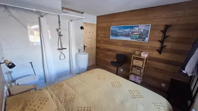 a bedroom with a bed in a room with wooden walls at La Karabane de Clément in Chamonix-Mont-Blanc