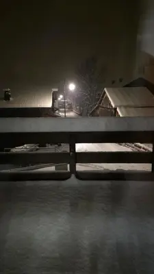 a night time view of a snow covered parking lot at La Karabane de Clément in Chamonix-Mont-Blanc
