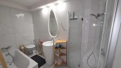 a bathroom with a shower and a sink and a toilet at La Karabane de Clément in Chamonix-Mont-Blanc