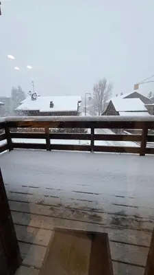 a fence in the snow with snow on the ground at La Karabane de Clément in Chamonix-Mont-Blanc