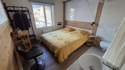 a small bedroom with a bed and a sink at La Karabane de Clément in Chamonix-Mont-Blanc