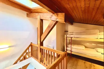 a room with two bunk beds and a staircase at Stay in the mountains with stunning views in Combloux