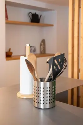 a metal container filled with utensils on a kitchen counter at Appartement lumineux - 8 personnes - Wifi - Lave-linge - Au pied des pistes et des transports in Chamonix-Mont-Blanc