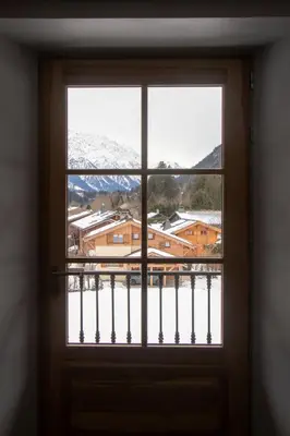 a window with a view of a snowy mountain at Appartement lumineux - 8 personnes - Wifi - Lave-linge - Au pied des pistes et des transports in Chamonix-Mont-Blanc