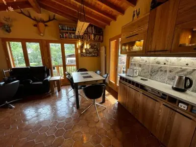 a kitchen with a table and a living room at Chalet K2 in Megève