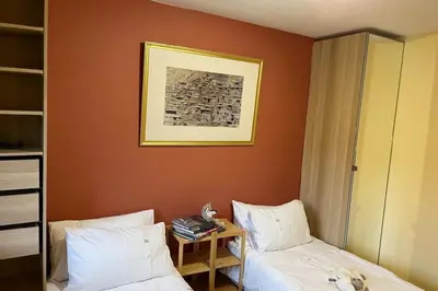 a hotel room with two beds and a table at Chalet K2 in Megève