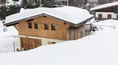 a snow covered house with snow on top of it at Chalet K2 in Megève