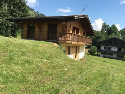 a house on top of a grassy hill at Chalet K2 in Megève