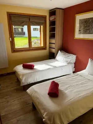 two beds in a room with red walls at Chalet K2 in Megève