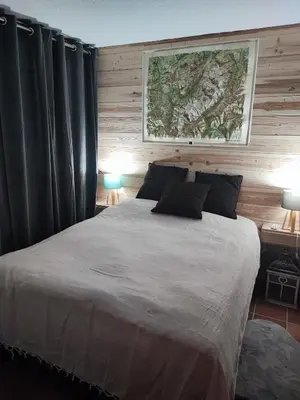 a bedroom with a large bed with black curtains at Le pied des pistes télésiège des chattrix in Saint-Gervais-les-Bains