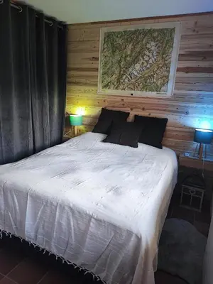 a bedroom with a large white bed with two lamps at Le pied des pistes télésiège des chattrix in Saint-Gervais-les-Bains
