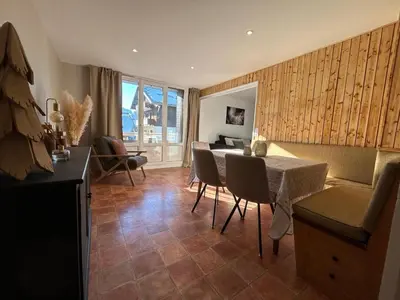 a living room with a table and chairs at Appartement Mélèzes in Megève