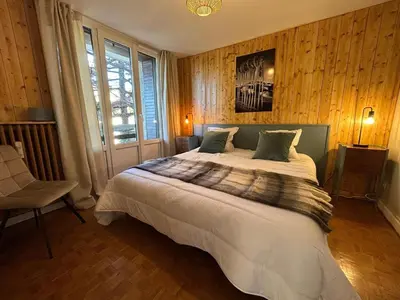 a bedroom with a large bed and a window at Appartement Mélèzes in Megève