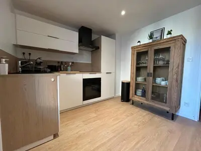 a kitchen with a wooden cabinet in a room at Appartement Mélèzes in Megève