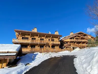 a large wooden house in the snow at Megève : Appartement de luxe 115m², 6 pers, accès pistes, Wifi - FR-1-569-203 in Megève