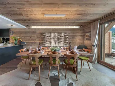 a dining room with a table and some chairs at Megève : Appartement de luxe 115m², 6 pers, accès pistes, Wifi - FR-1-569-203 in Megève