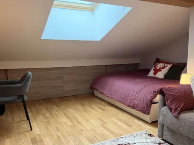 a attic bedroom with a bed and a skylight at Appart neuf 3 ch 8 pers près patinoire avec balcon et parking - FR-1-572-347 in Arâches-la-Frasse