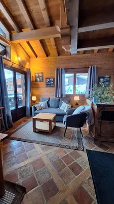 a living room with a blue couch and a table at Chalet Inouk 4 people Chamonix center in Chamonix-Mont-Blanc