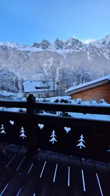a snow covered bench with a view of the mountains at Chalet Inouk 4 people Chamonix center in Chamonix-Mont-Blanc