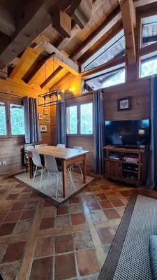 a dining room with a table and a tv at Chalet Inouk 4 people Chamonix center in Chamonix-Mont-Blanc