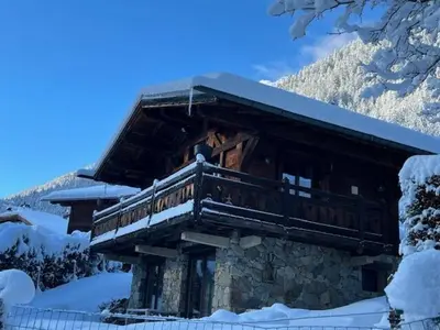 a log cabin with a balcony in the snow at Chalet Inouk 4 people Chamonix center in Chamonix-Mont-Blanc