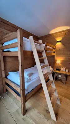 a bunk bed in a room with a ladder at Chalet Inouk 4 people Chamonix center in Chamonix-Mont-Blanc