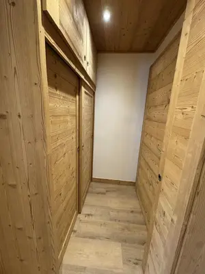 a room with wooden walls and wooden doors at Les Carroz - Rénové - Au cœur de la station - 4 pers in Arâches-la-Frasse