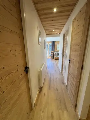 a hallway with wooden walls and a wooden floor at Les Carroz - Rénové - Au cœur de la station - 4 pers in Arâches-la-Frasse