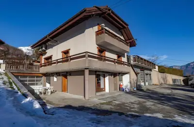 a house with a balcony on the side of it at Appartement Le Daguet in Sallanches