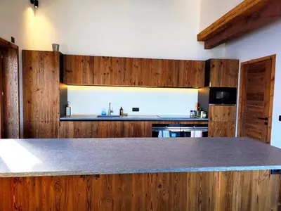 a kitchen with wooden cabinets and a counter top at Les trois Massifs in Saint-Gervais-les-Bains