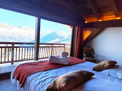 a bedroom with a bed with a view of mountains at Les trois Massifs in Saint-Gervais-les-Bains