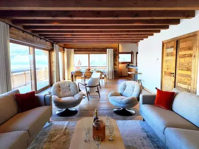 a living room with couches and chairs and a table at Les trois Massifs in Saint-Gervais-les-Bains
