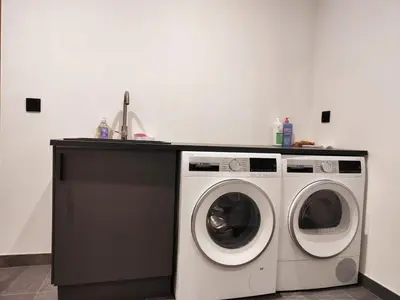 a kitchen with a washing machine and a sink at Les trois Massifs in Saint-Gervais-les-Bains