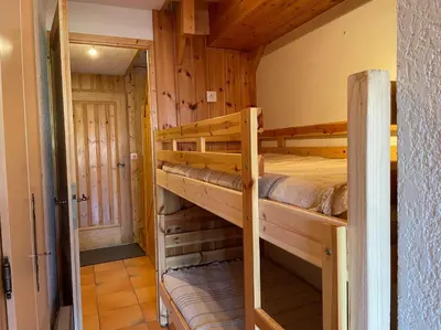a bedroom with two bunk beds in a cabin at Duplex with fantastic view 3 bedrooms 7-9 pers in Arâches-la-Frasse