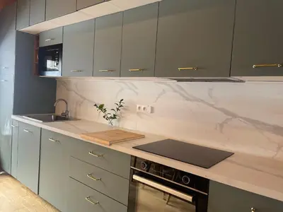 a kitchen with white marble counter tops and a sink at Duplex with fantastic view 3 bedrooms 7-9 pers in Arâches-la-Frasse