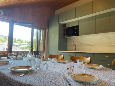 a table with plates and wine glasses on it at Duplex with fantastic view 3 bedrooms 7-9 pers in Arâches-la-Frasse