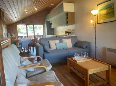 a living room with a couch and a table at Duplex with fantastic view 3 bedrooms 7-9 pers in Arâches-la-Frasse