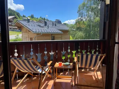 two chairs and a table on a balcony at Duplex with fantastic view 3 bedrooms 7-9 pers in Arâches-la-Frasse
