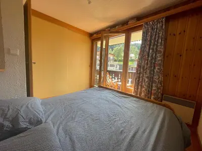 a bedroom with a bed and a large window at Duplex with fantastic view 3 bedrooms 7-9 pers in Arâches-la-Frasse