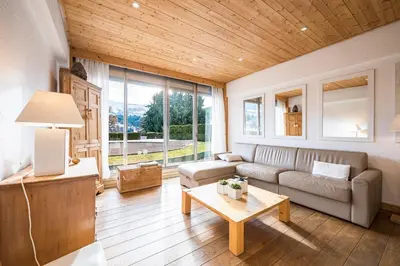 a living room with a couch and a table at L'Opale de Megève - station ski accessible à pied in Megève