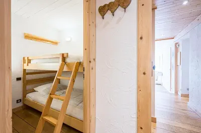 a bunk bed in a room with a ladder at L'Opale de Megève - station ski accessible à pied in Megève
