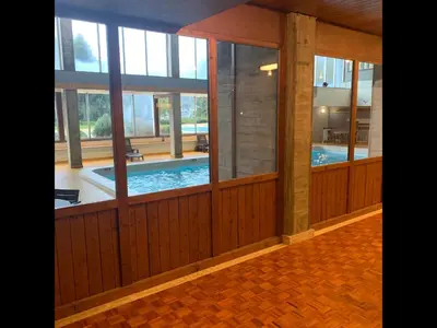 a house with a swimming pool and windows at L'Opale de Megève - station ski accessible à pied in Megève