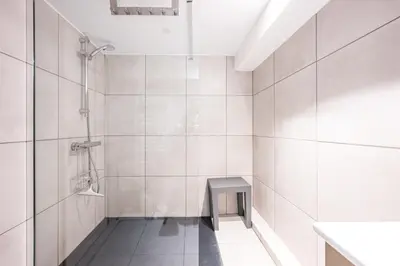a white bathroom with a shower and a sink at L'Opale de Megève - station ski accessible à pied in Megève