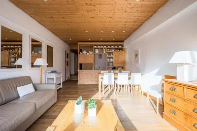 a living room with a couch and a table at L'Opale de Megève - station ski accessible à pied in Megève
