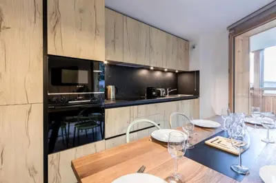 a kitchen with a table with wine glasses on it at Bright apartment ideal in Les Houches for 4 in Les Houches
