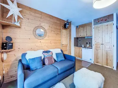 a living room with a blue couch and a window at Studio Topaze-1 by Interhome in Saint-Gervais-les-Bains