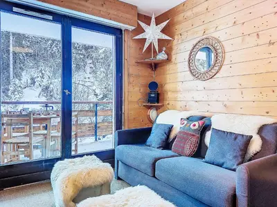 a table on a balcony with a view of snow covered trees at Studio Topaze-1 by Interhome in Saint-Gervais-les-Bains